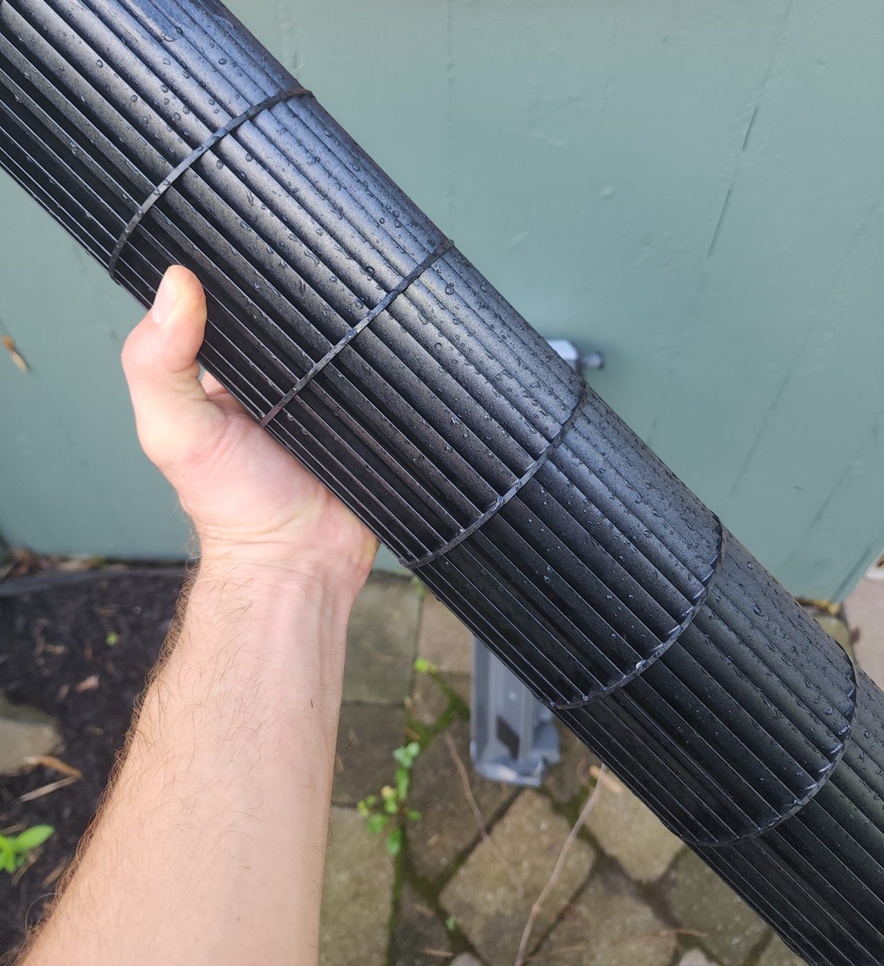 The same style of mini-split blower wheel after cleaning, glossy black and rinsed